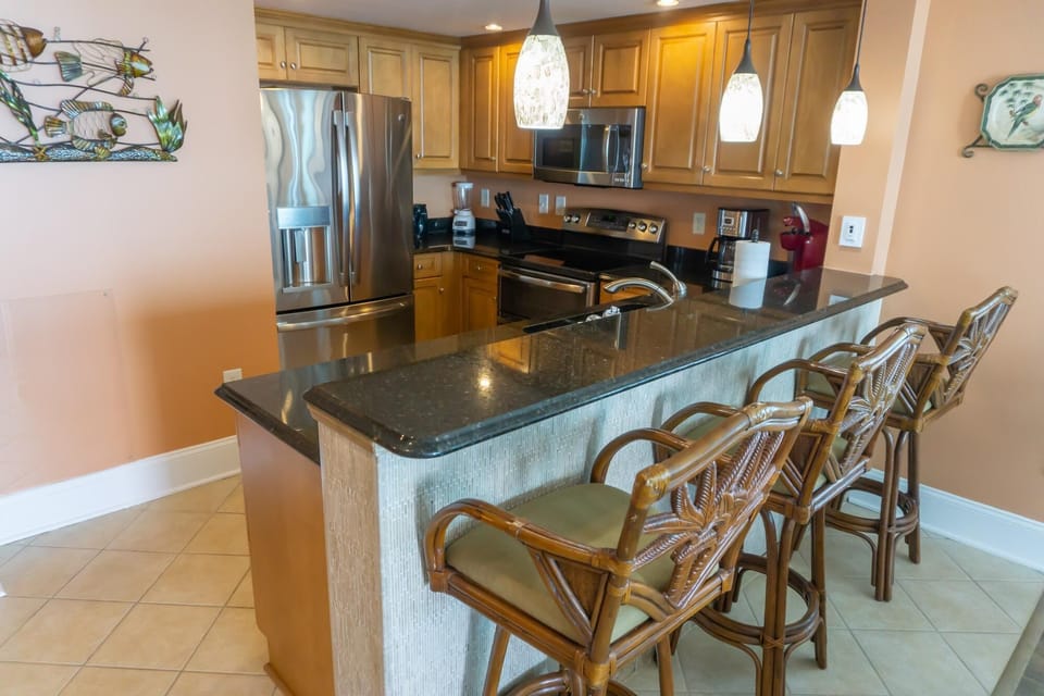 Spacious kitchen with granite island and cozy bar seating