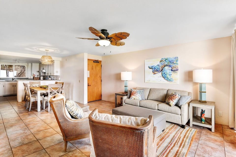 Tropical vibes meet cozy elegance in this airy living and dining room!