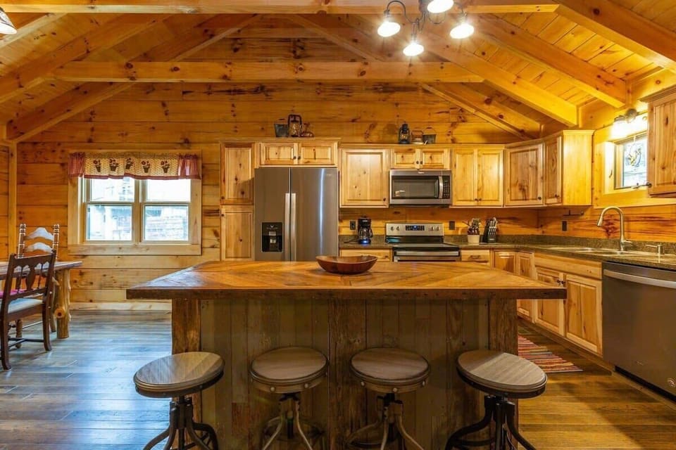 Barstool seating in the spacious kitchen with cathedral ceiling and gorgeous hardwoods!
