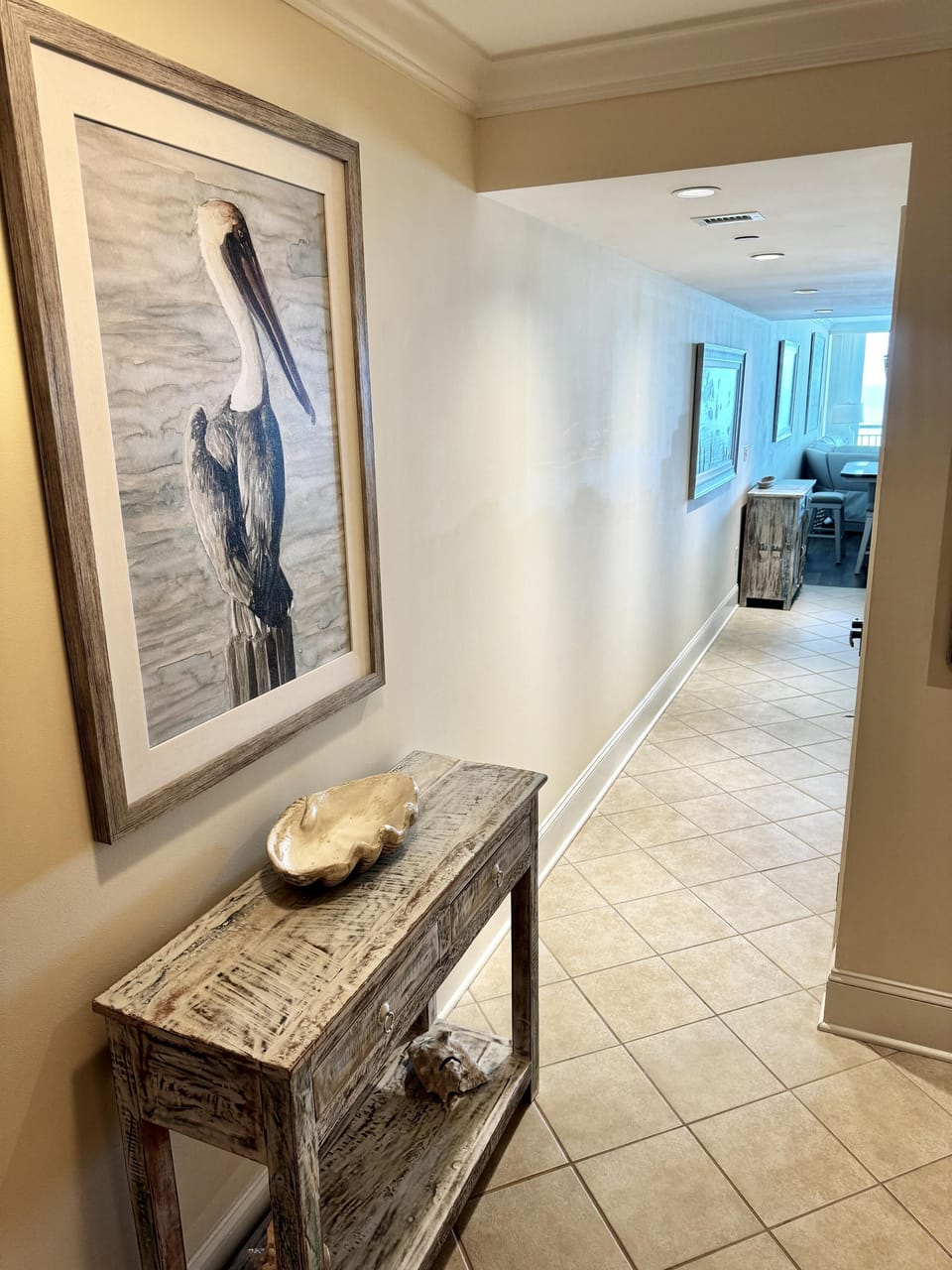 Welcoming entryway with elegant coastal artwork and decor