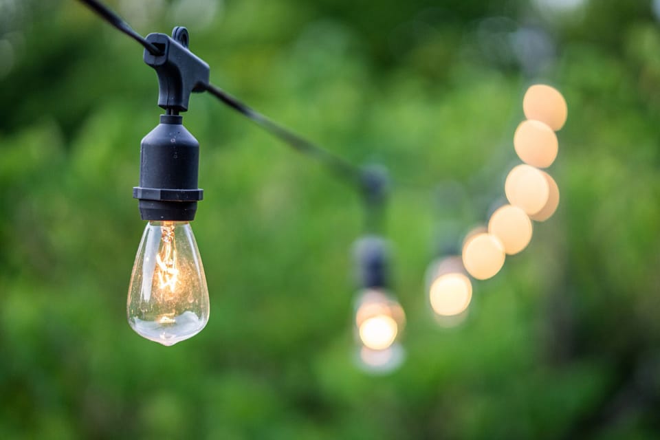 Experience a magical ambiance in our outdoor space with enchanting market string lights, creating a cozy and inviting atmosphere for memorable gatherings and relaxation.