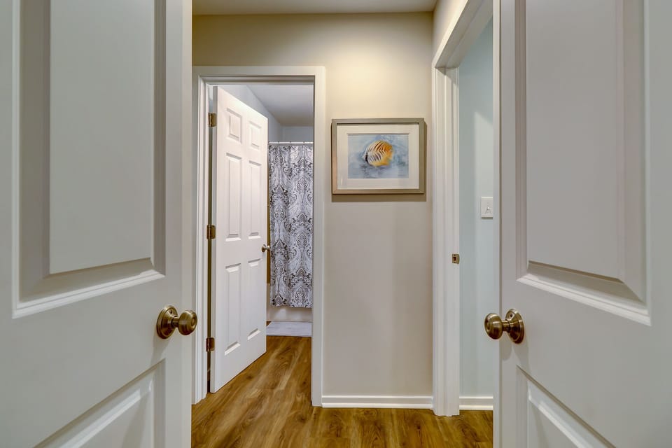 Hallway off the main living space into the first floor master and guest bed/bath