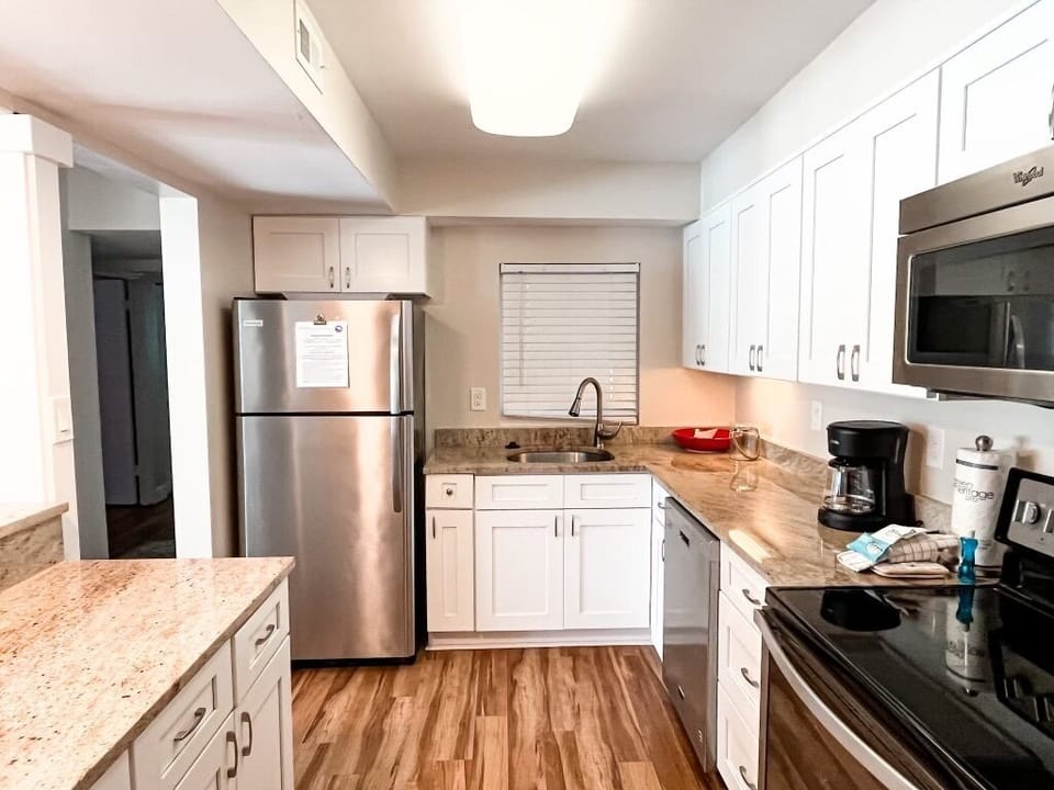 Kitchen features stainless steel appliances throughout.