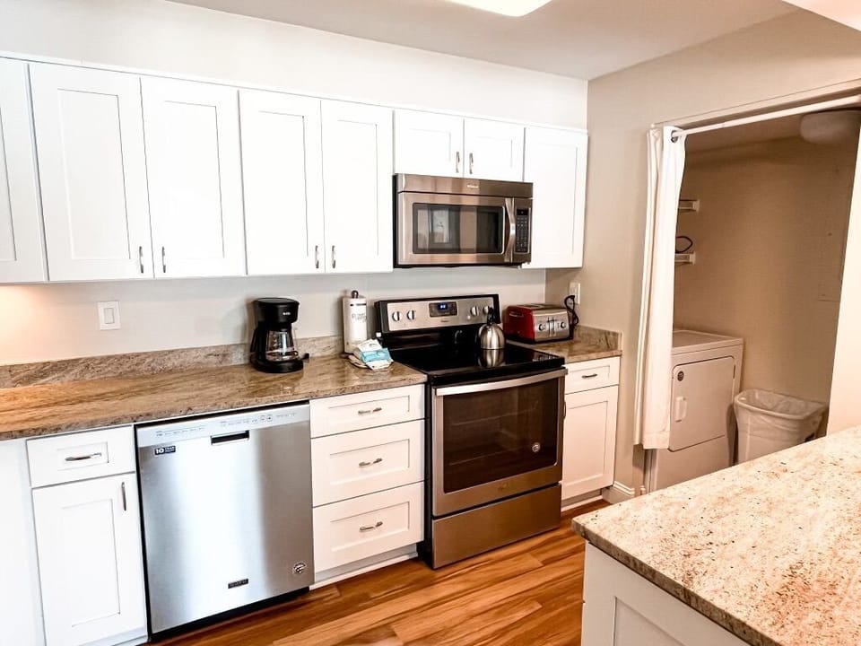 Plenty of counterspace and cabinets in kitchen and connecting laundry area.