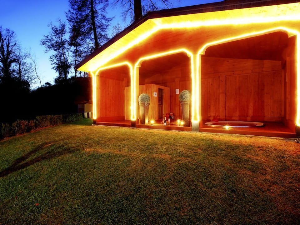 The sauna and hot tub at night time.