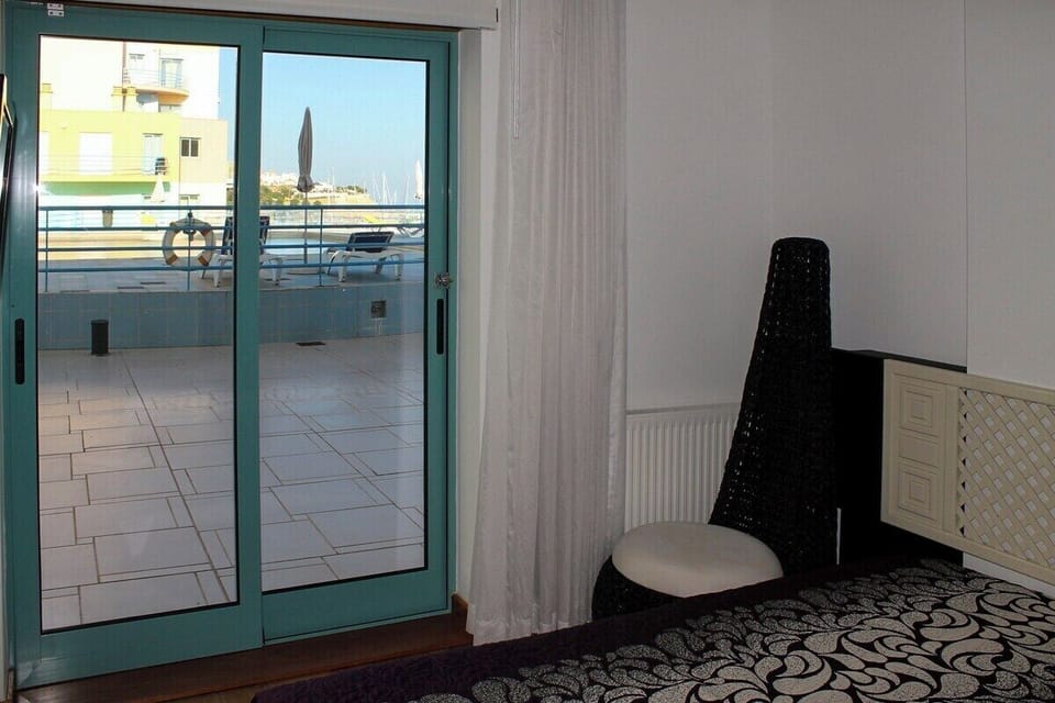 En-suite bedroom with door leading to pool