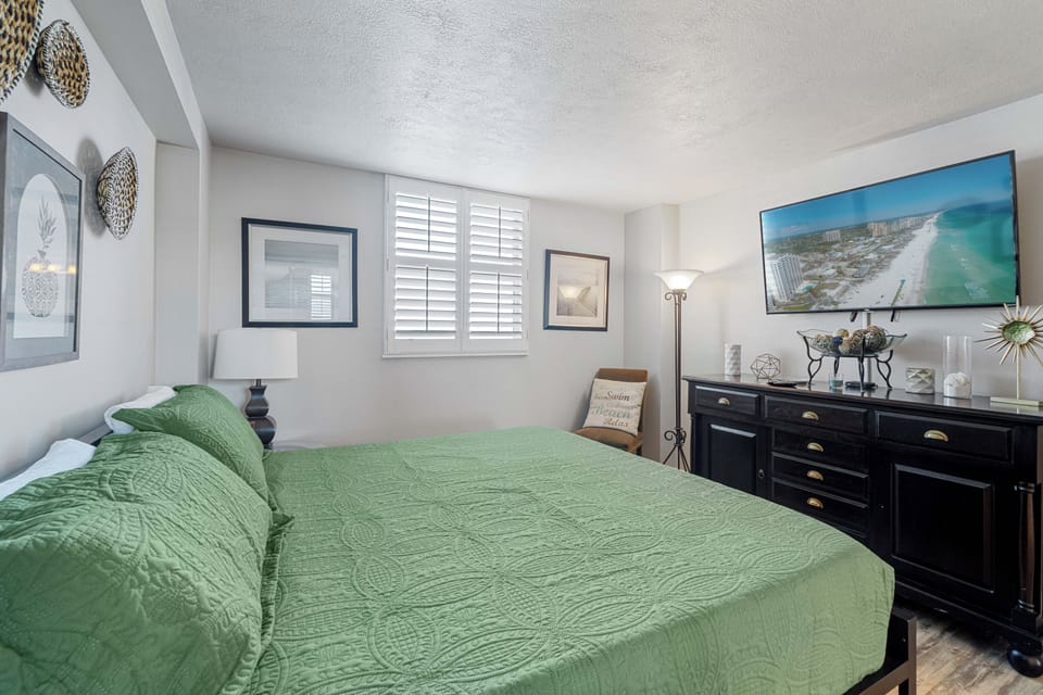 Guest Bedroom furnished w/ king mattress, chest of drawers and mounted smart TV