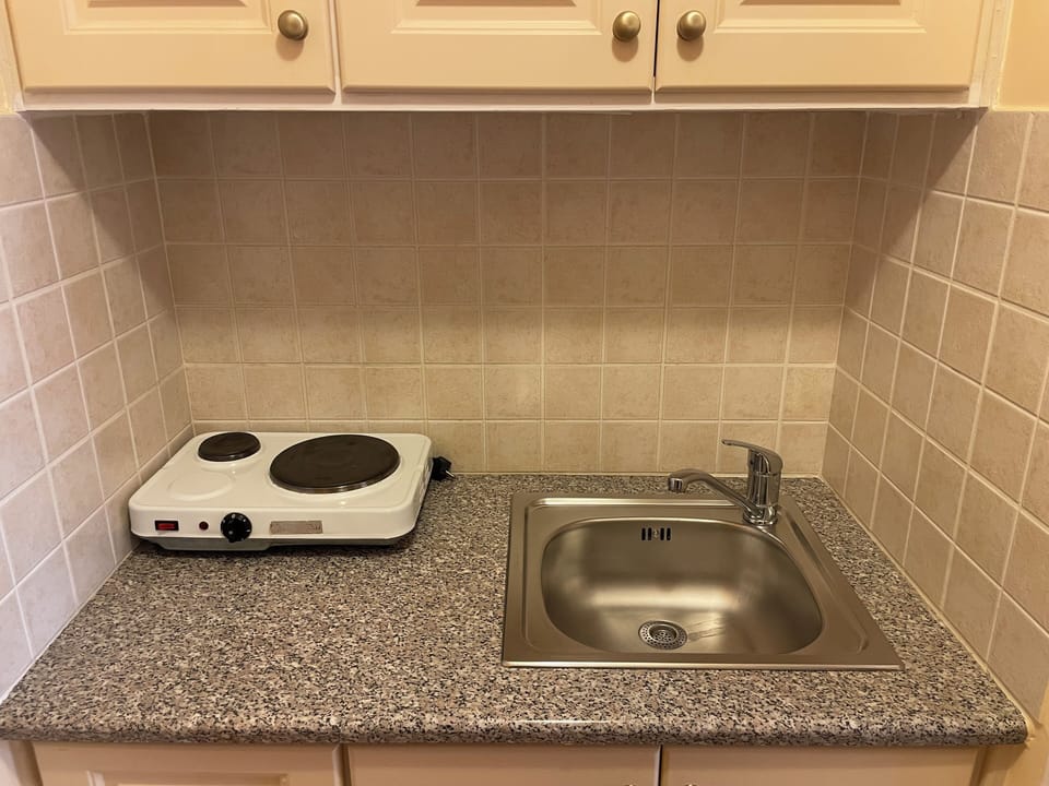 Fridge, electric kettle, dining tables
