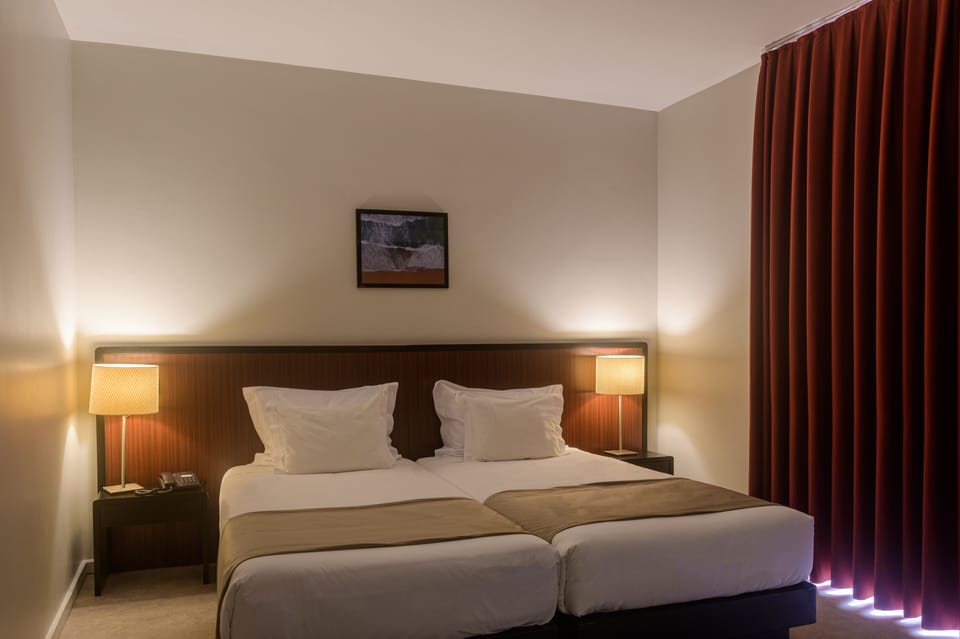 Twin Room | Minibar, in-room safe, desk, soundproofing