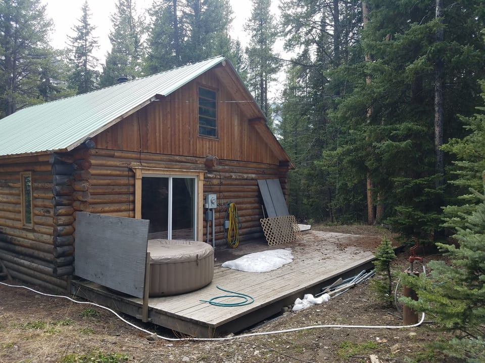 Rear deck with door to bedroom. Note inflatable hot tub. Simple but enjoyable.