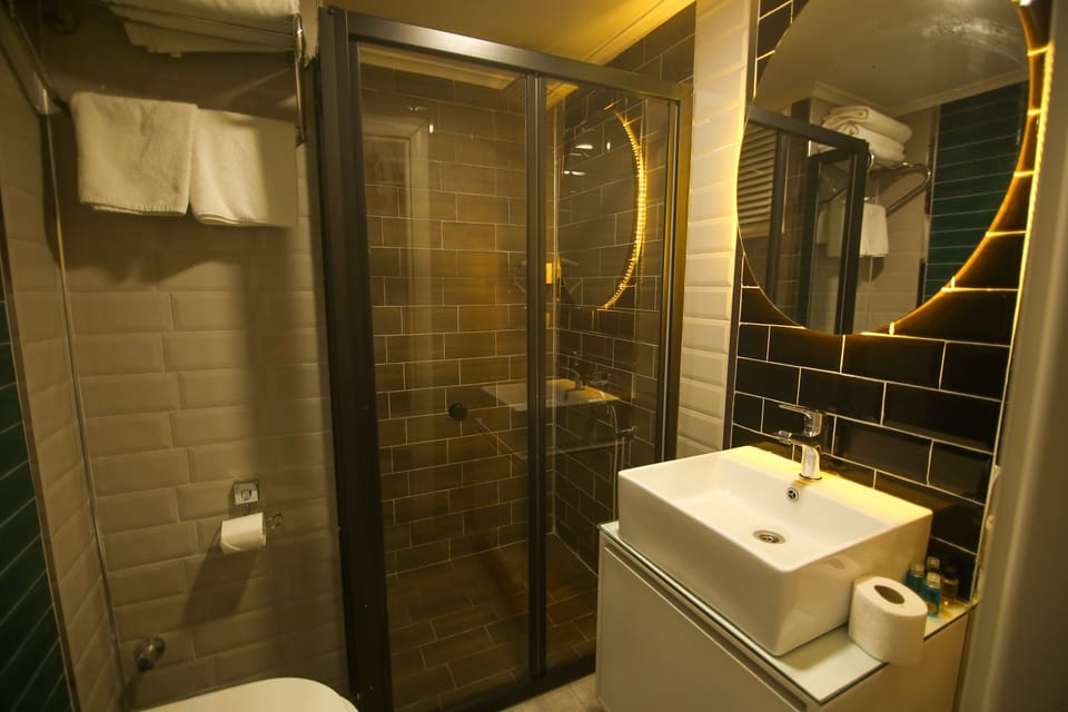 Shower, designer toiletries, hair dryer, slippers