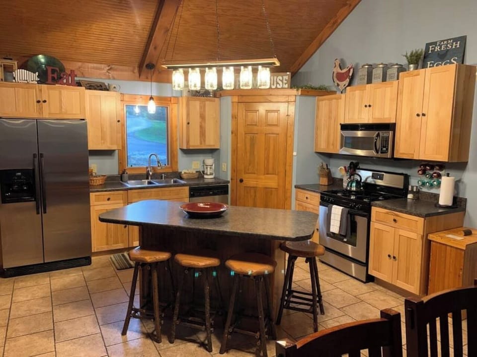 This inviting kitchen offers stainless appliances, a central island, and rustic touches that make meal prep easy and enjoyable.