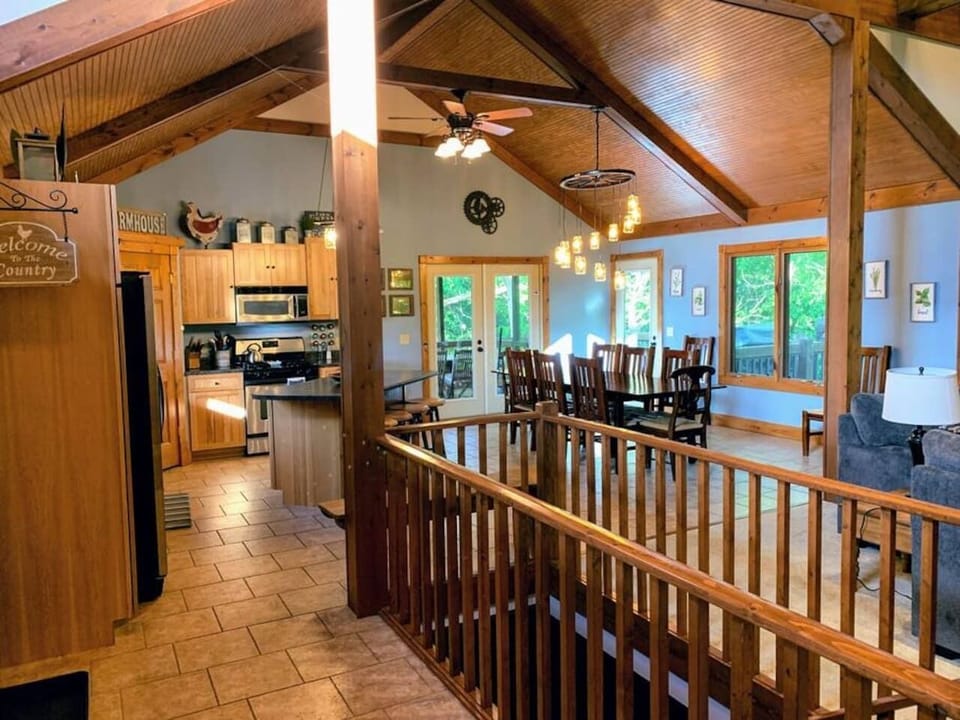 A beautifully designed open-concept space featuring a country kitchen, farmhouse dining table, and cozy living area — perfect for family meals and group gatherings.
