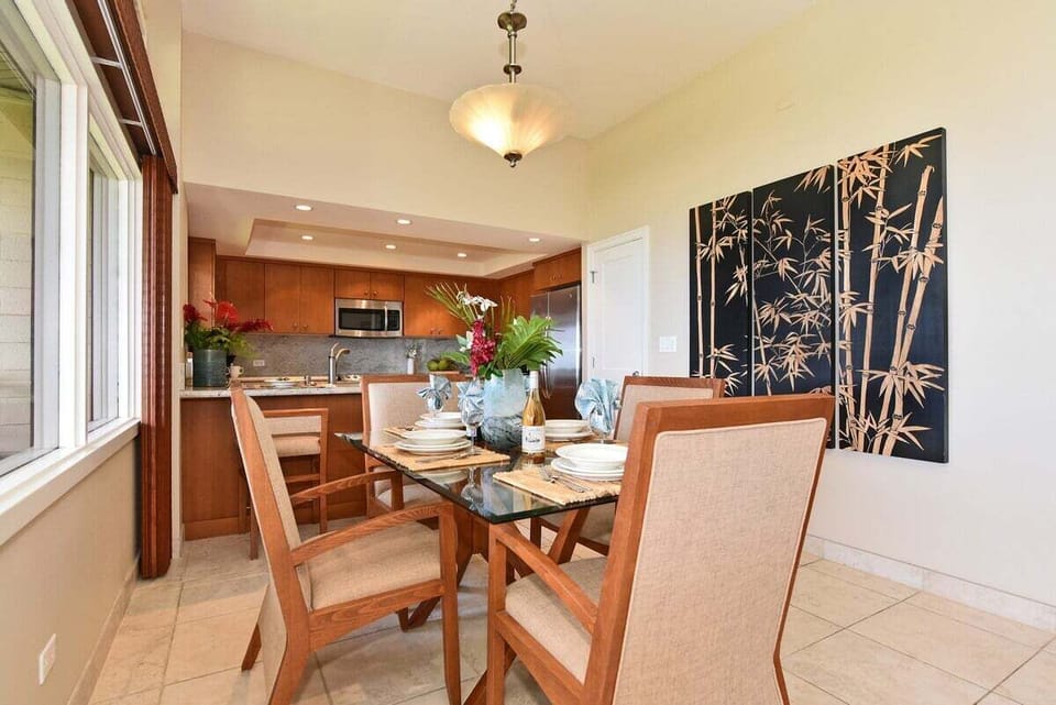 Dining area with seating for four, natural light, and open layout connecting the kitchen and living room.