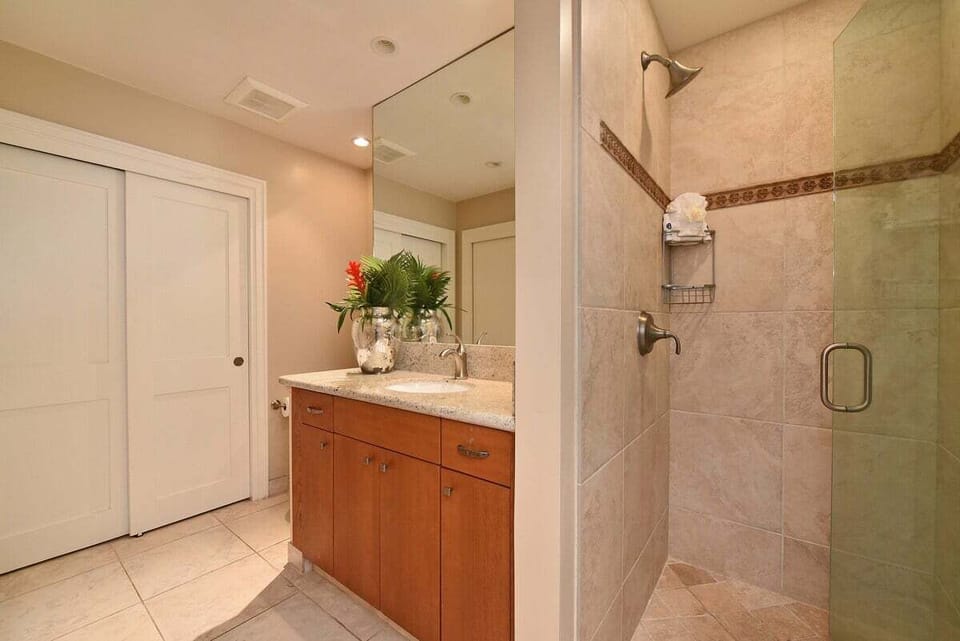 Walk-in shower with tiled walls, glass enclosure, and modern fixtures for a spa-like bathroom experience.