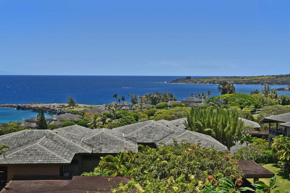 Scenic ocean-view lanai perspective with rolling greenery and coastal views highlighting the natural beauty of Kapalua.