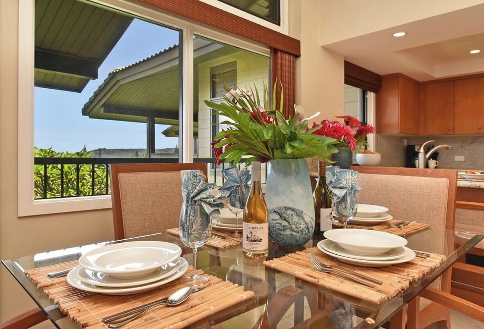Indoor-outdoor dining setup with stylish tableware, large windows, and easy access to the private ocean-view lanai.