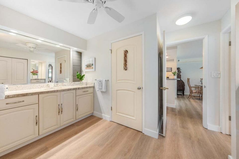 Spacious bathroom with large vanity and tiled step-in shower