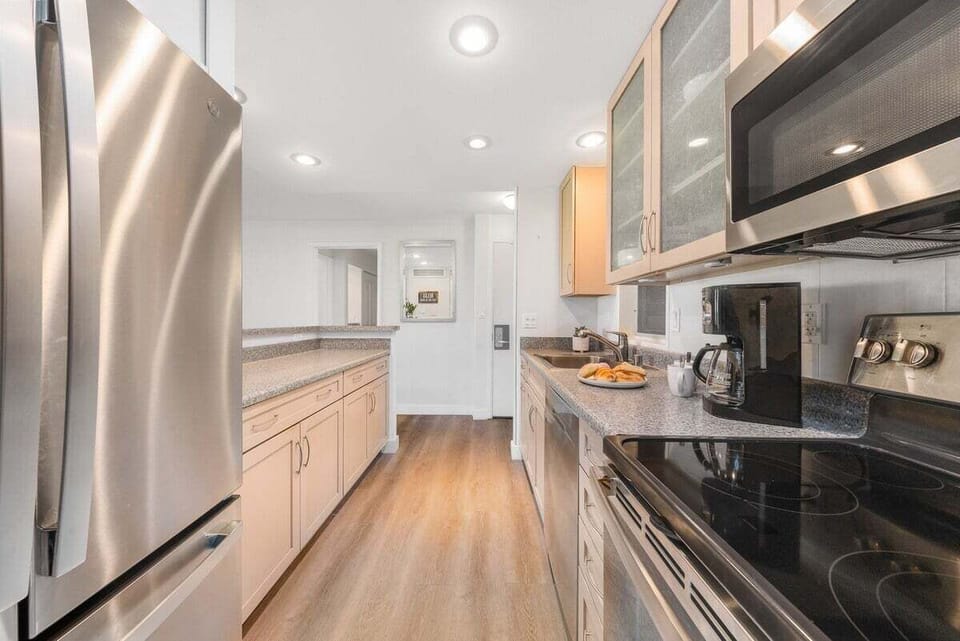 Fully equipped kitchen with modern stainless steel appliances