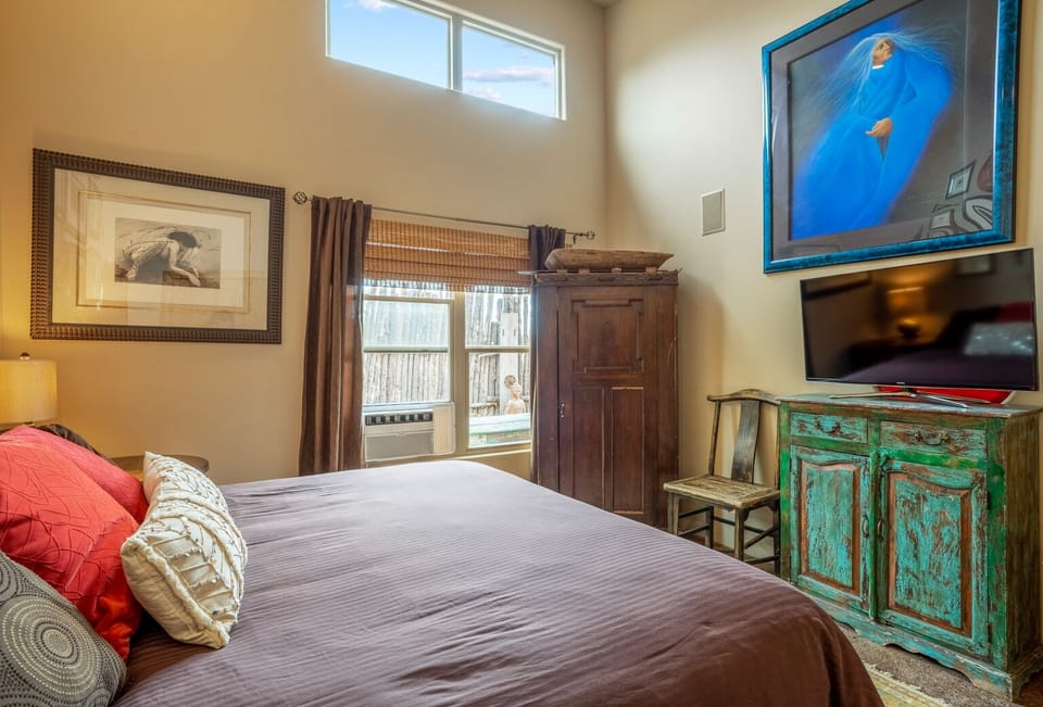 Master king suite with original southwest art, hdtv, hanging closet and AC.