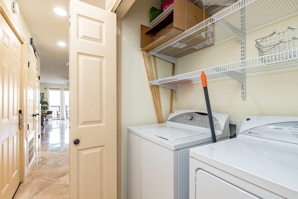 Your laundry area features full-size washer and dryer with convenient shelving for supplies and linens.