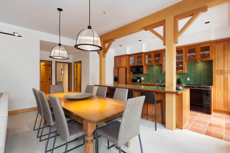 - Elegant dining area with seating for eight and stylish pendant lighting  
- Open-concept flow to kitchen for easy entertaining and family gatherings  
- Rustic wood accents create a warm mountain dining atmosphere  