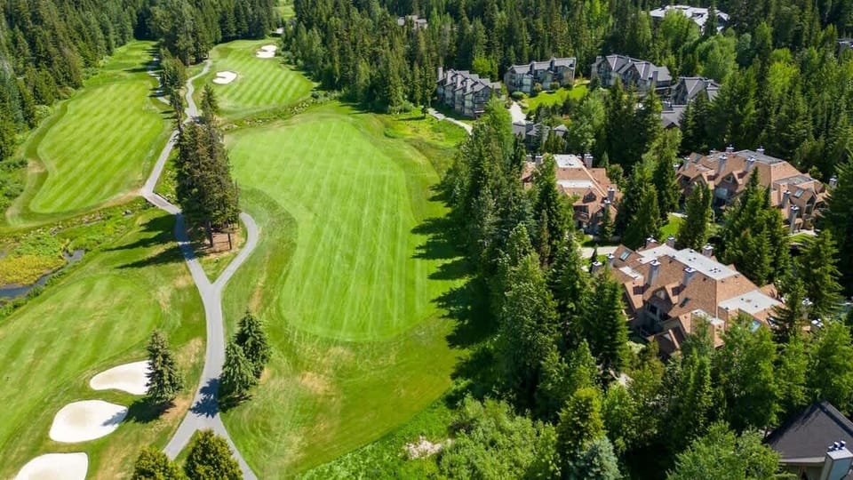 - Aerial view of Whistler’s Fairmont golf course and forest greens  
- Beautiful landscape for golf lovers surrounded by mountain views  
- Perfect mix of recreation, relaxation, and natural scenery  