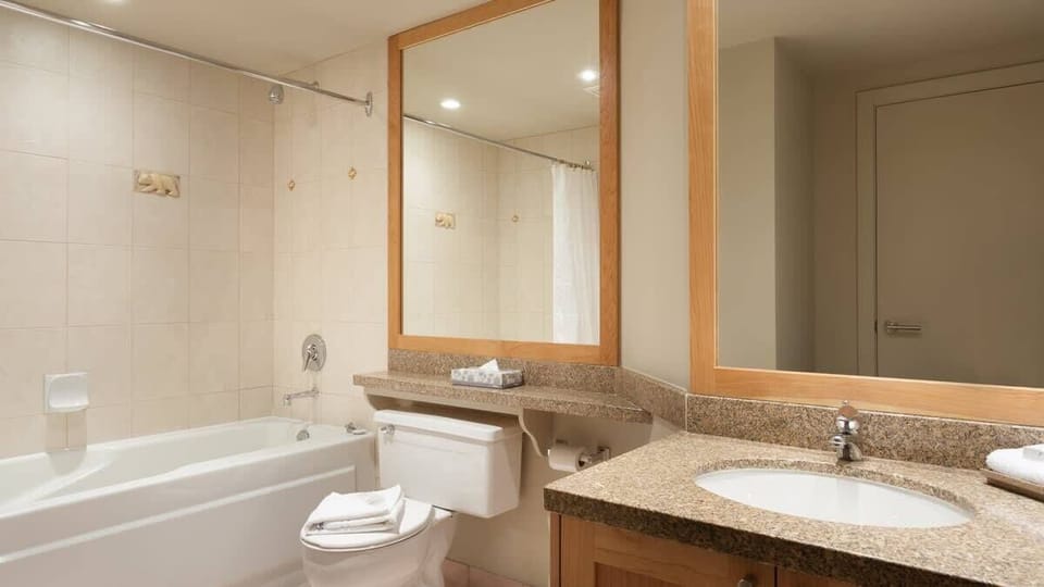 - Bright bathroom with granite vanity and full-size bathtub for relaxation  
- Clean modern design with large mirror and warm lighting throughout  
- Perfect for refreshing after a day of skiing or mountain exploration  