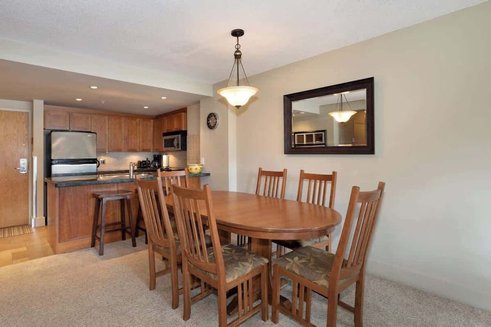 - Spacious dining area with wooden table perfect for shared meals  
- Open to kitchen and living space for easy connection and comfort  
- Enjoy hearty dinners after an exciting day on Whistler slopes 