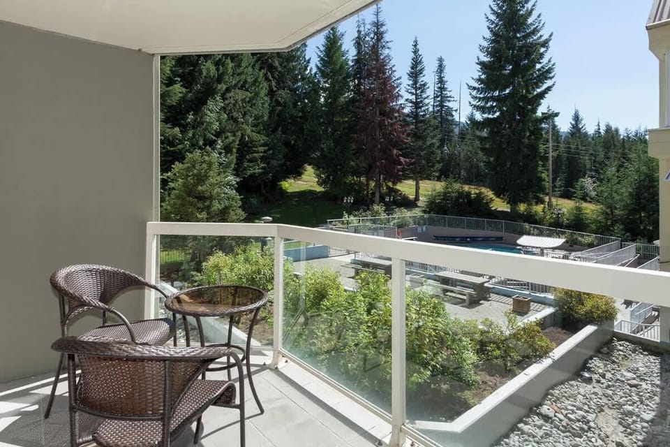 - Private balcony with seating overlooking pool and forested mountain views  
- Perfect for morning coffee or evening wine under the alpine sky  
- Tranquil outdoor space connecting you to nature in Whistler’s heart  
