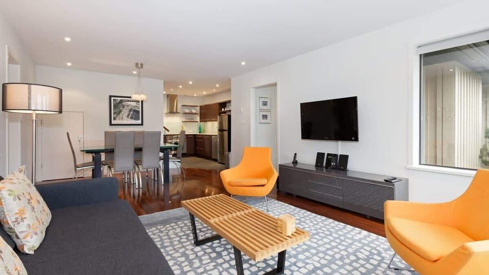 Open-concept living & dining area w/ modern furnishings, perfect for gathering after a day out.