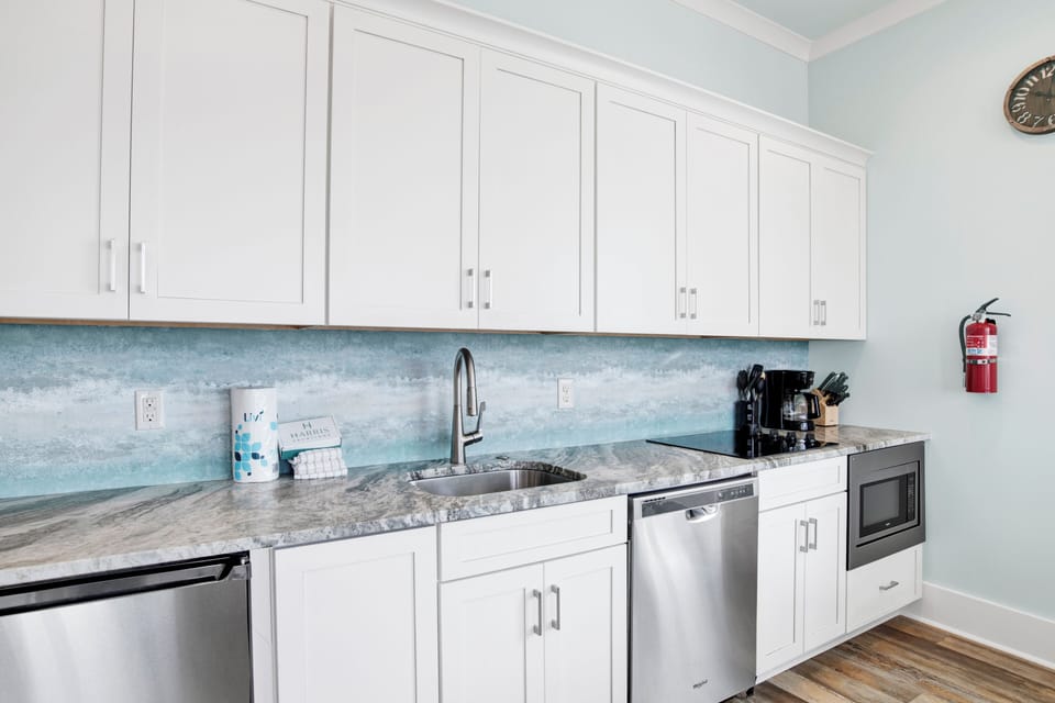 The 2nd kitchen offers stone counters and stainless appliances