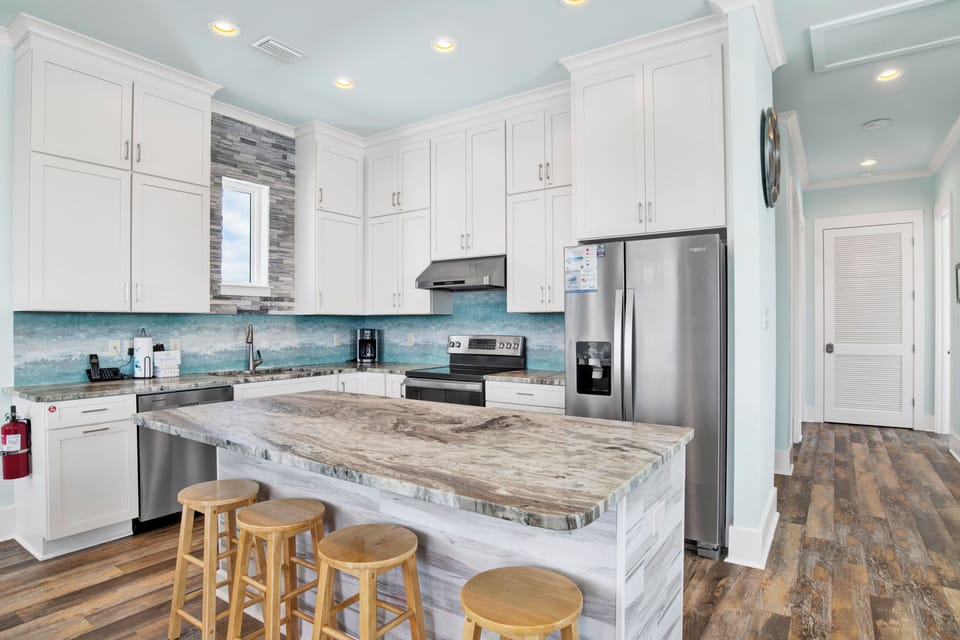 The main kitchen is fully equipped, has stone counters and stainless appliances