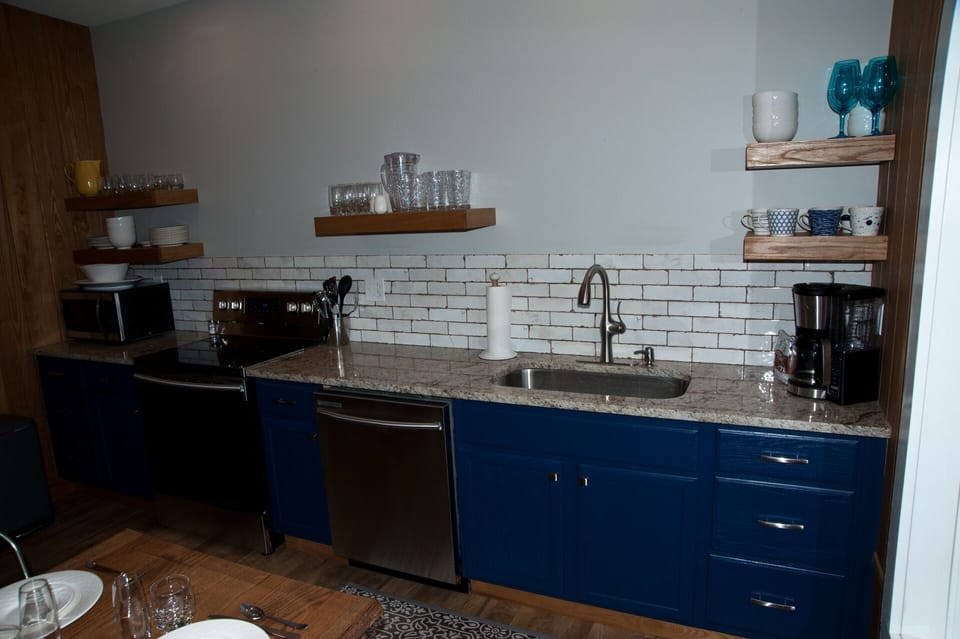 Coffee maker, dishwasher, smooth top stove and microwave.