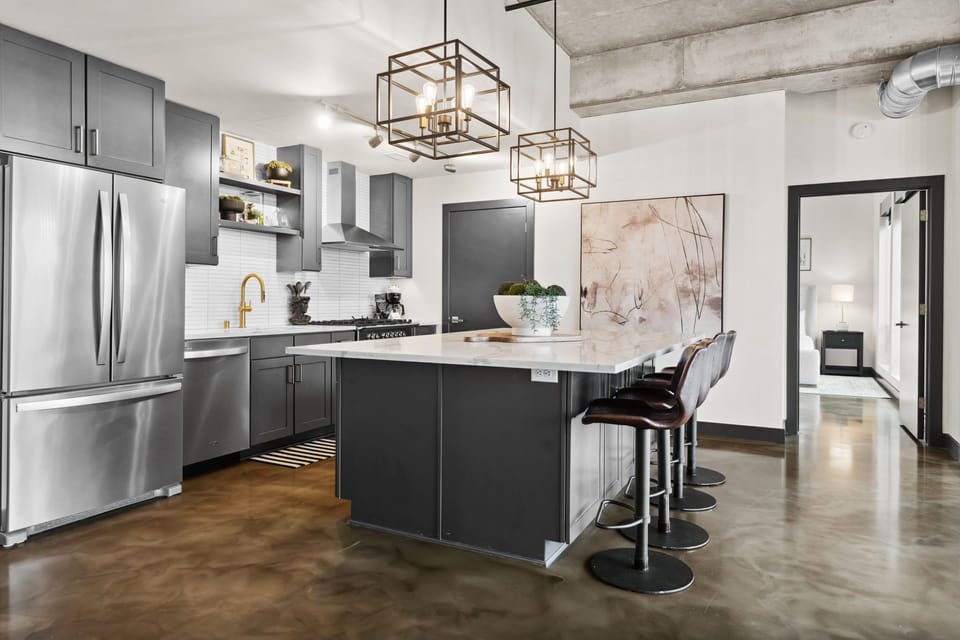 Your sleek modern kitchen features stainless steel appliances and a marble island where you can cook memorable meals together.