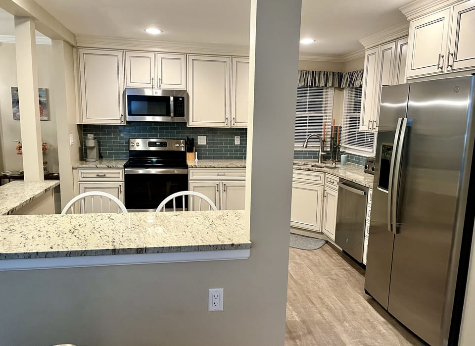 View of Kitchen from Living Room and Foyer 