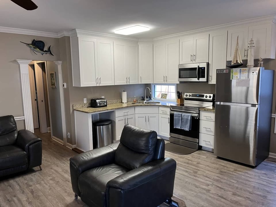 Kitchen equipped with fridgerator/ice maker, fulll size stove/oven, microwave, blender, mixer dishes and utensils.