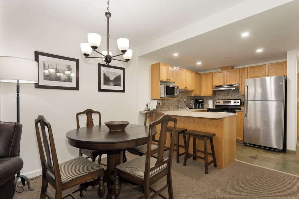 - Warm dining area adjacent to a modern open kitchen for easy meals  
- Classic wooden furniture creates a cozy alpine ambiance  
- Gather for memorable breakfasts or après-ski dinners with loved ones  