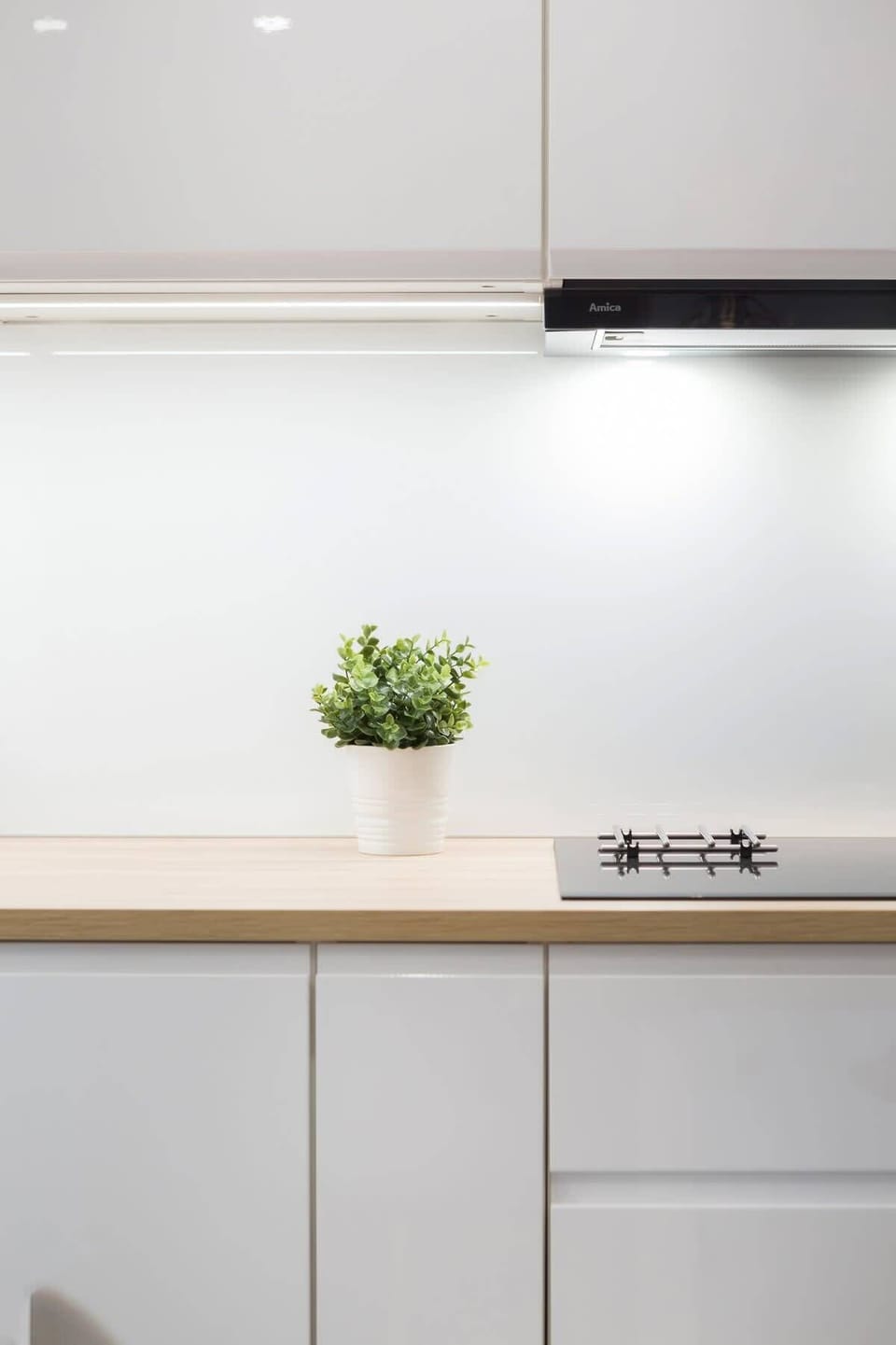 Modern kitchenette with electric kettle.