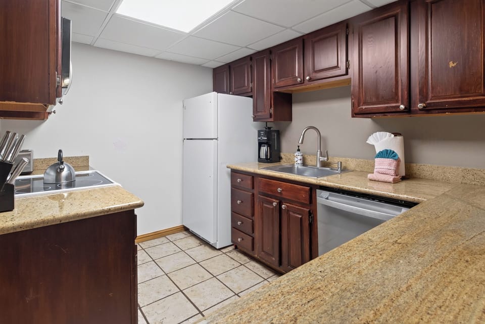 Full Kitchen. Some Cabinets Show Wear and Tear.