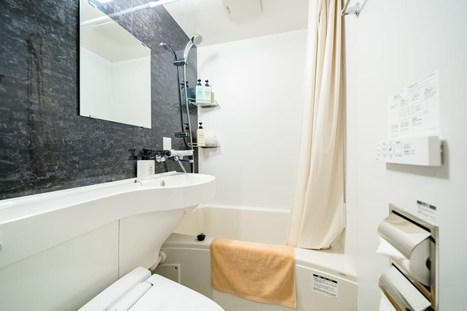Combined shower/tub, free toiletries, hair dryer, slippers