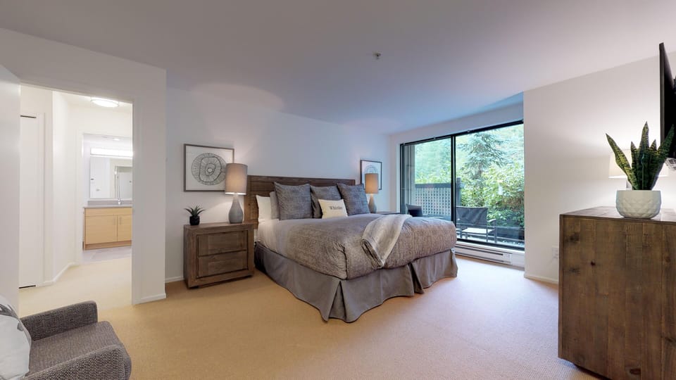 Primary bedroom with king bed and view to courtyard