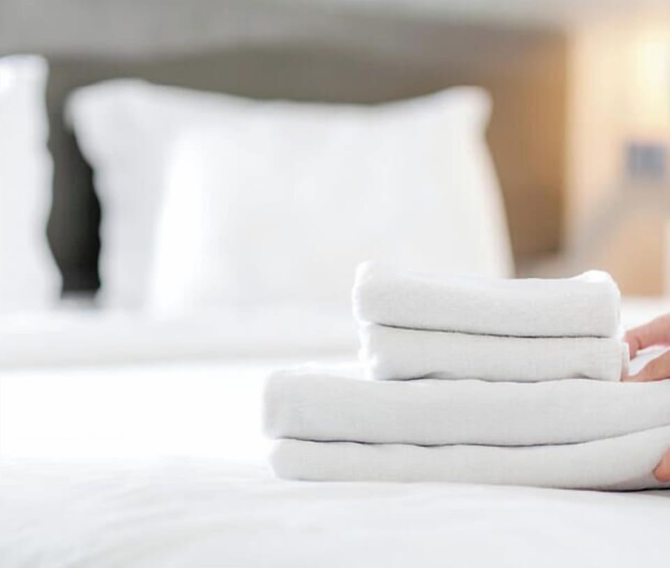 Fresh, fluffy towels await you, perfectly stacked on your bed—ready for your beach days and after every relaxing shower.