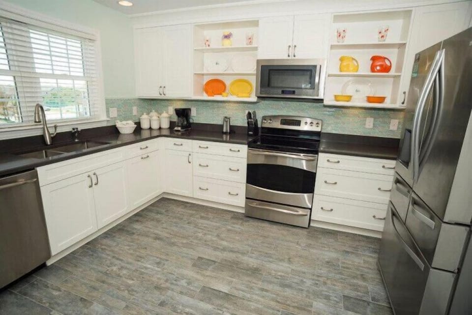 Your fully equipped kitchen awaits with modern stainless appliances, sleek countertops, and cheerful pops of color. Bright natural light and smart storage make meal prep a breeze in this inviting space.