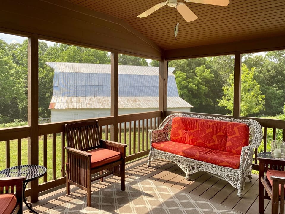 Screened in porch for dining, chatting, and enjoying amazing farm sunsets.