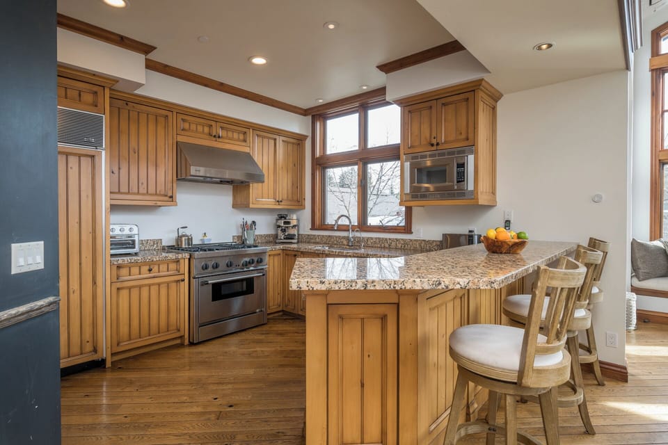 Your gourmet kitchen awaits with granite counters, professional appliances, and warm wood cabinetry—perfect for preparing memorable meals together.