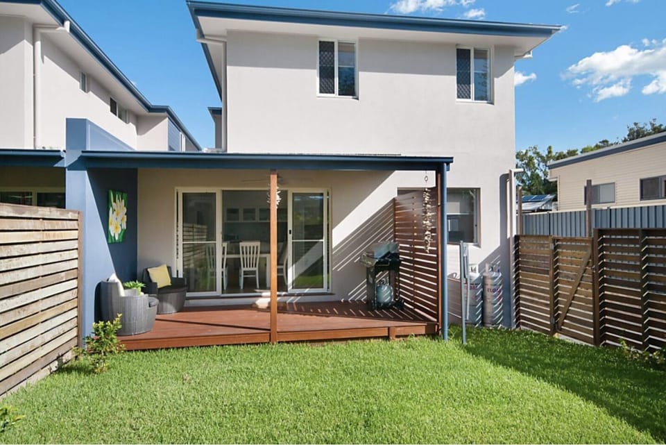 back of property showing private garden and deck with BBQ