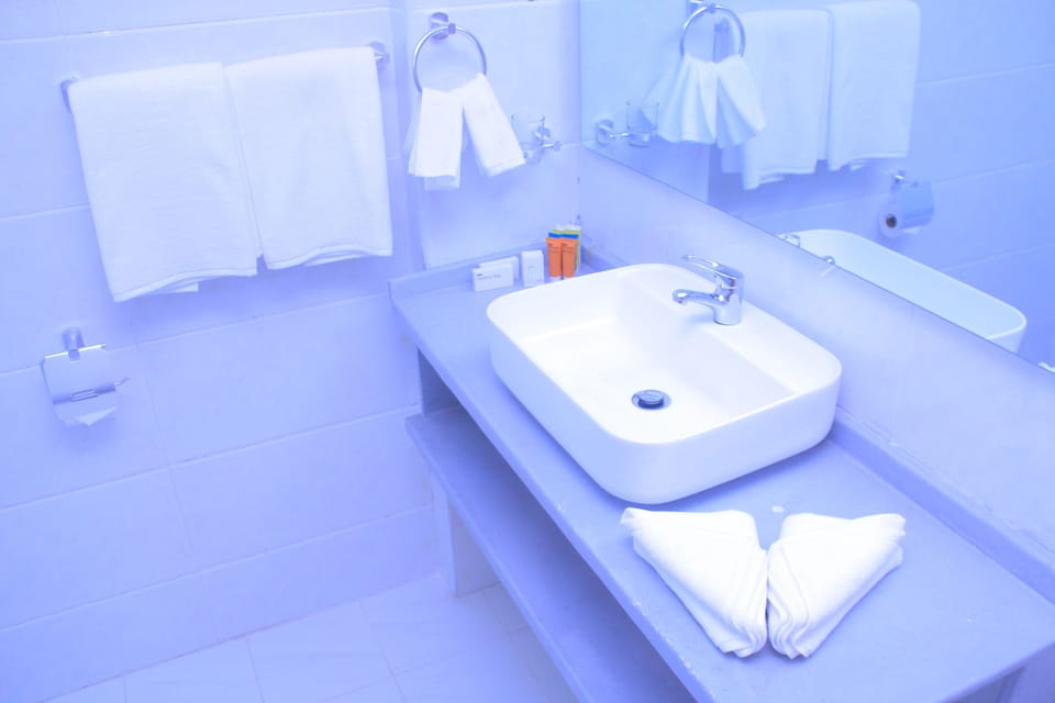 Shower, rainfall showerhead, slippers, towels