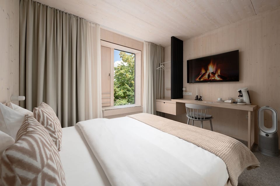 Hypo-allergenic bedding, desk, laptop workspace, blackout drapes