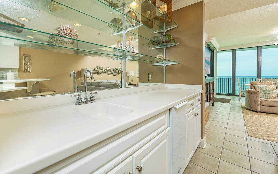 A wet bar offers a cool spot to prepare drinks while you hear the gentle retreat of waves nearby